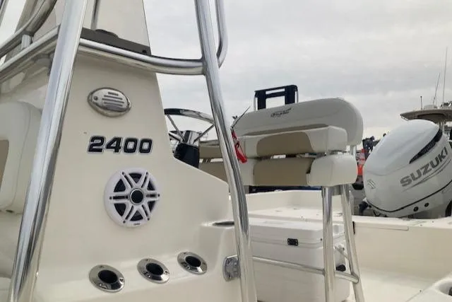 Slide: The Image of 2023 Bulls Bay 2400 boat interior with Suzuki engine, featuring seating and control panel. - 3