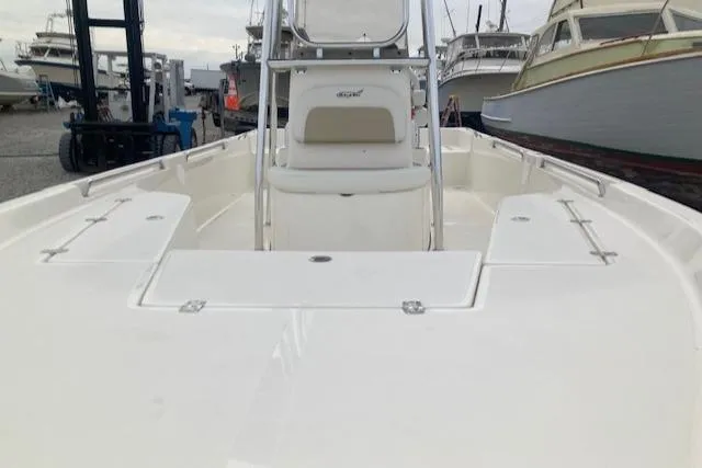 Slide: The Image of 2023 Bulls Bay 2400 boat, white deck, marina background, multiple boats visible. - 5