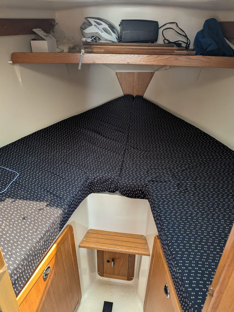 Slide: The Image of 1997 Catalina MkII cabin interior with V-berth and storage shelves. - 10