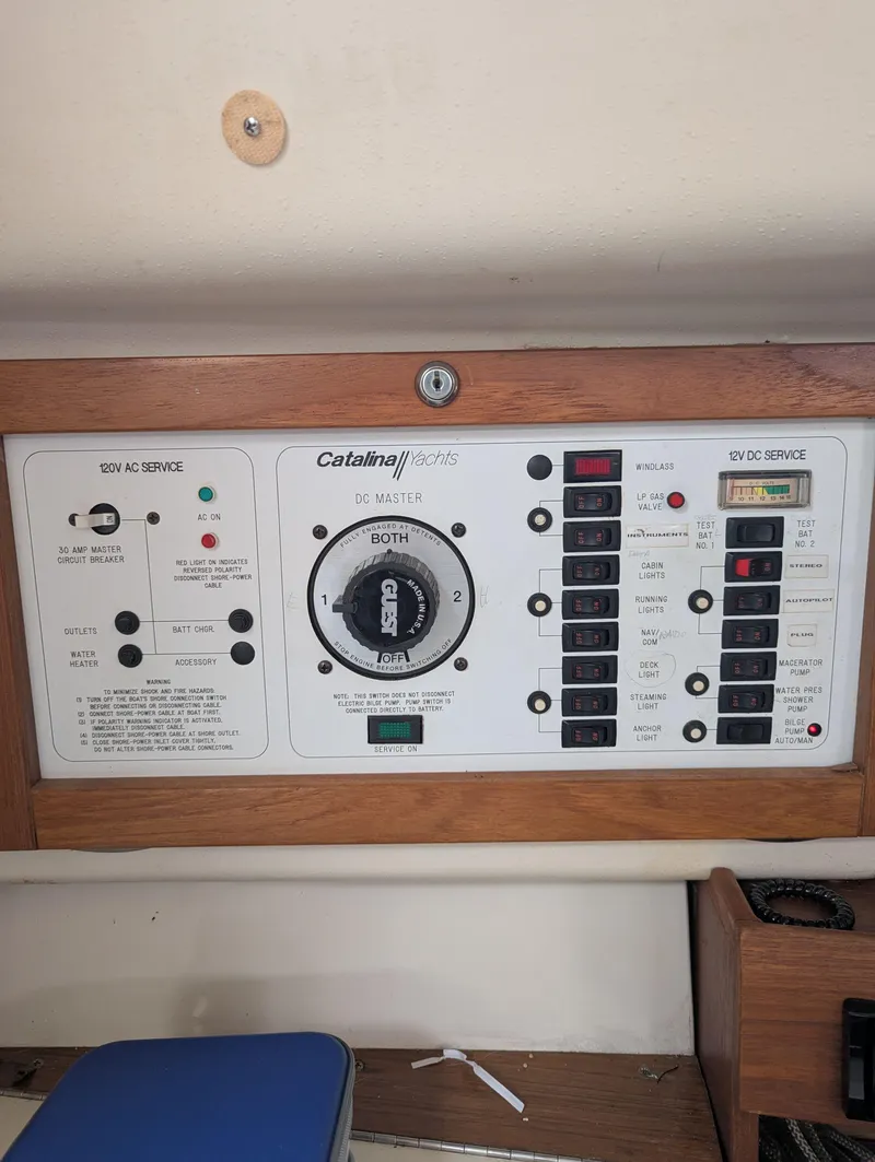 Slide: The Image of Control panel of a 1997 Catalina MkII sailboat with switches and dials. - 12