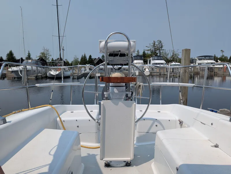 Slide: The Image of Cockpit view of a 1997 Catalina MkII sailboat docked at a marina. - 3