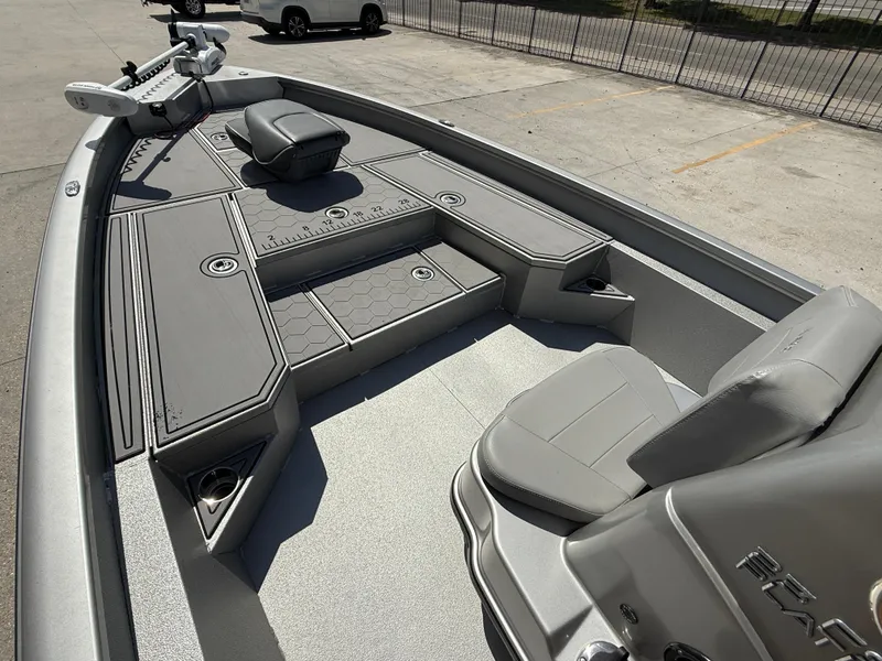 Slide: The Image of 2021 Avid FS23 Mag Platinum boat on trailer, American flag, outdoor setting. - 11