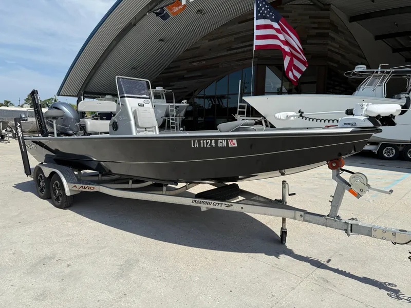 Slide: The Image of Avid FS23 Mag Platinum 2021 boat on trailer in parking lot. - 2