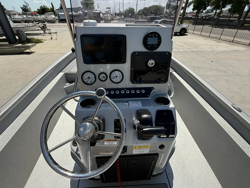 Slide: The Image of 2021 Avid FS23 Mag Platinum boat interior with gray seating and storage compartments. - 9