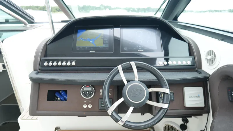 Slide: The Image of 2015 Cobalt A40 boat dashboard with steering wheel and navigation screens. - 11