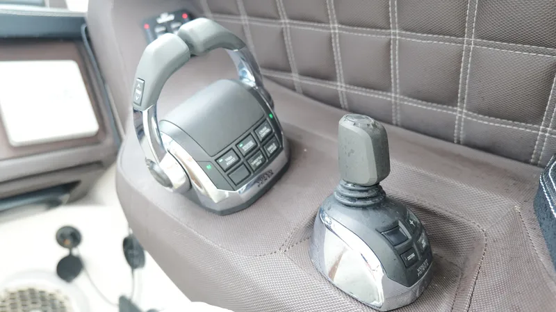 Slide: The Image of Control panel of a 2015 Cobalt A40 boat with joystick and buttons. - 14