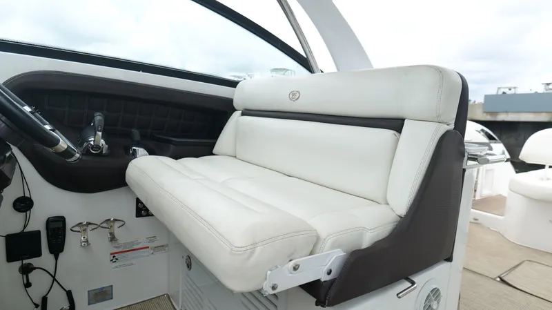 Slide: The Image of Luxurious white seating on 2015 Cobalt A40 boat, featuring sleek design and modern controls. - 15