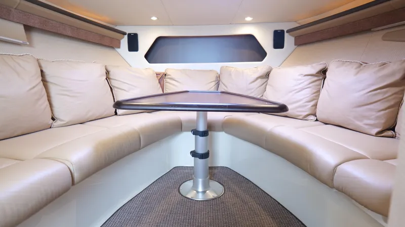 Slide: The Image of Luxurious interior of 2015 Cobalt A40 boat with beige seating and central table. - 17