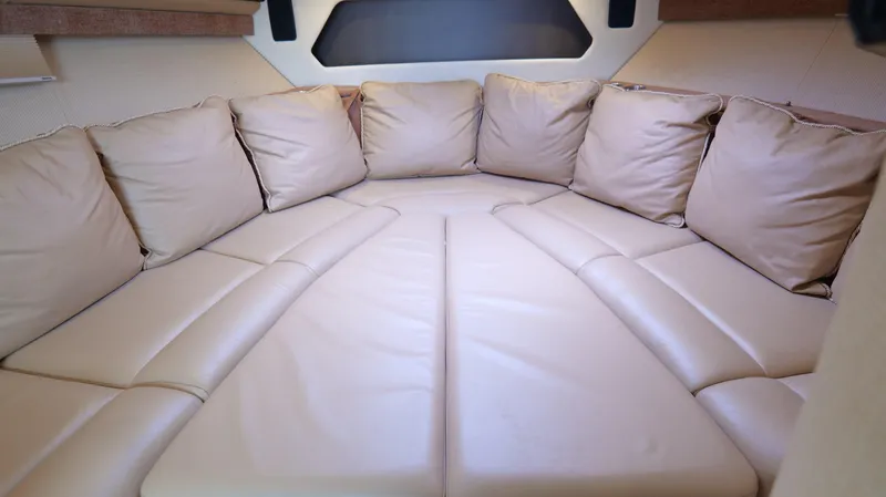 Slide: The Image of Luxurious beige seating area inside a 2015 Cobalt A40 boat cabin. - 18