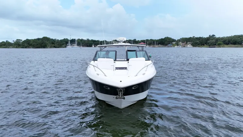 Slide: The Image of 2015 Cobalt A40 boat on calm water, front view, with scenic background. - 2
