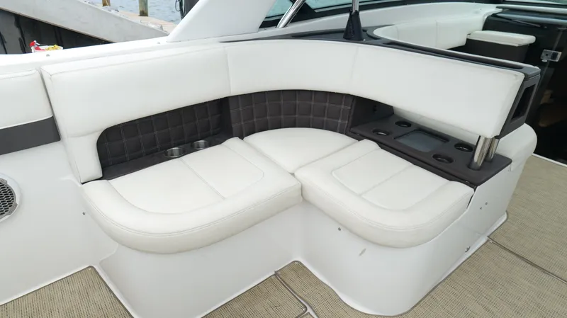 Slide: The Image of 2015 Cobalt A40 boat interior with white leather seating and cup holders. - 28
