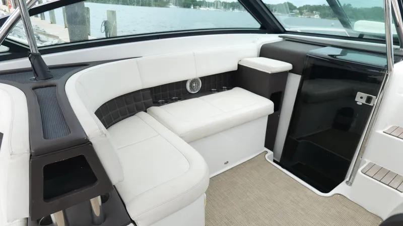 Slide: The Image of Interior of a 2015 Cobalt A40 boat with white seating and modern design. - 29
