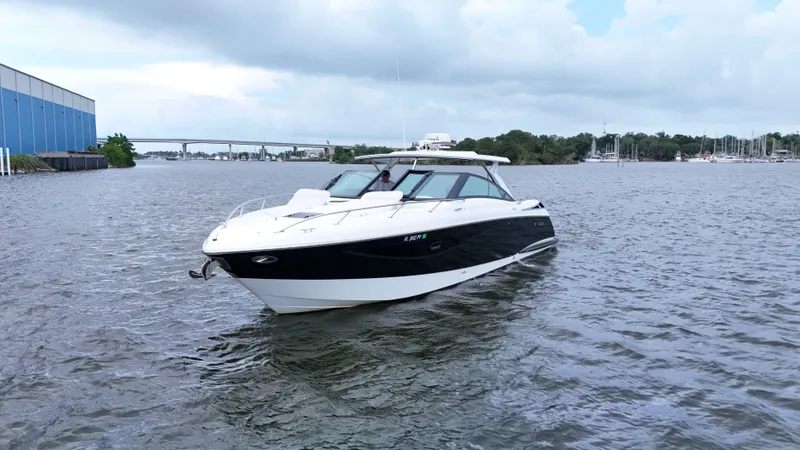 Slide: The Image of 2015 Cobalt A40 boat cruising on a calm river under cloudy skies. - 3