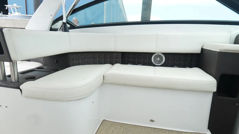 Slide: The Image of 2015 Cobalt A40 boat interior with white leather seating and speaker. - 30