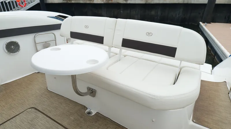Slide: The Image of 2015 Cobalt A40 boat interior with white seating and round table. - 31