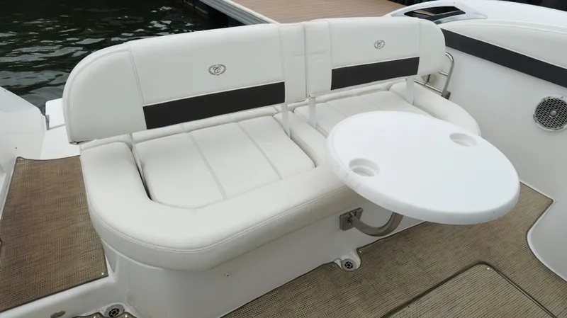 Slide: The Image of Luxury seating area on 2015 Cobalt A40 boat with white cushions and round table. - 32