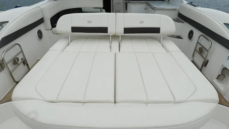 Slide: The Image of Luxurious seating area on a 2015 Cobalt A40 boat, featuring white cushioned upholstery. - 34