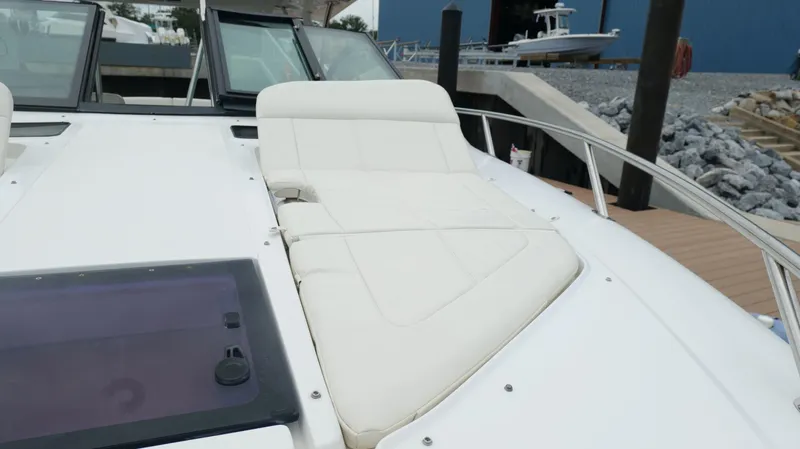 Slide: The Image of 2015 Cobalt A40 boat with white cushioned seating on deck. - 37