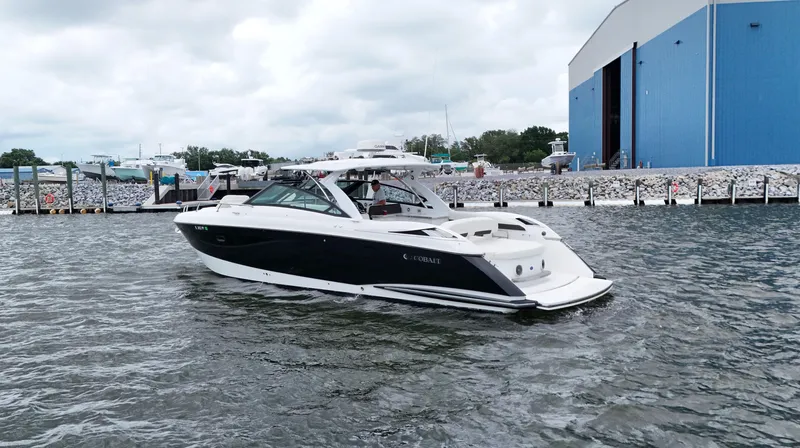 Slide: The Image of 2015 Cobalt A40 boat on water near a blue building. - 5