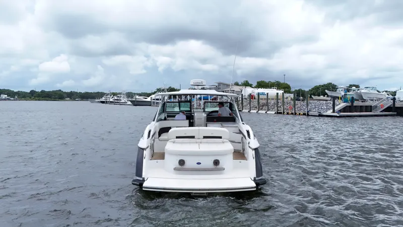 Slide: The Image of 2015 Cobalt A40 boat on water near marina under cloudy sky. - 6