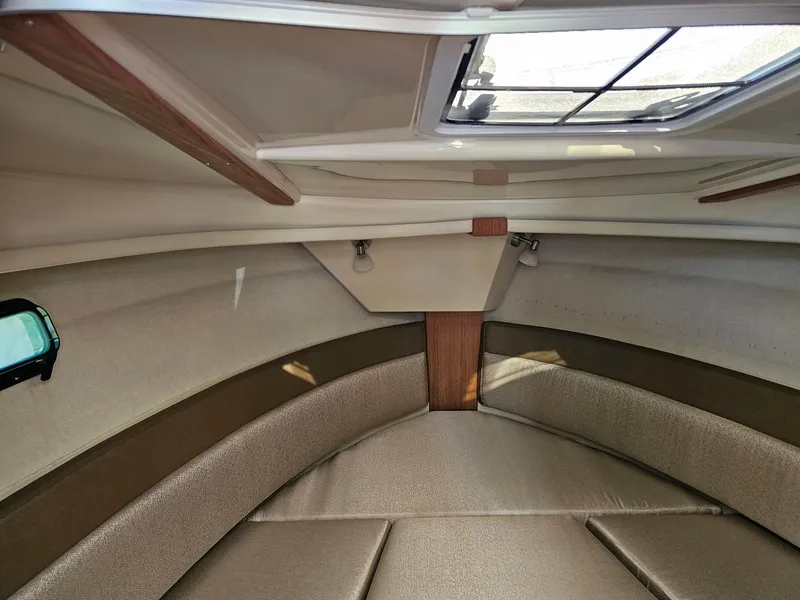 Slide: The Image of 2023 Ranger Tugs 27R cabin interior with skylight and seating area. - 18