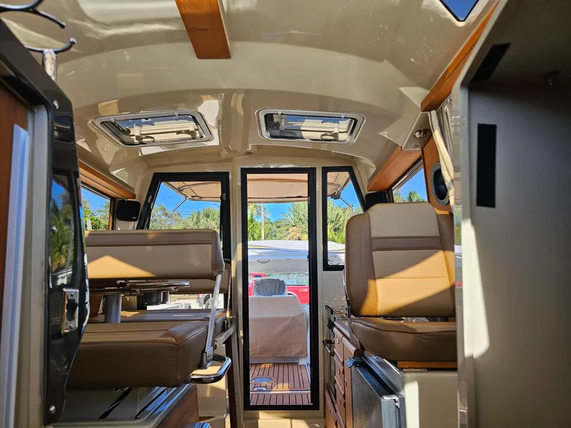 Slide: The Image of Interior of 2023 Ranger Tugs 27R boat, featuring seating and modern design elements. - 21