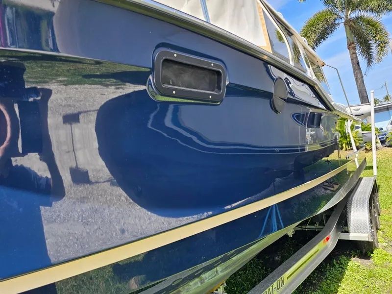 Slide: The Image of 2023 Ranger Tugs 27R boat with sleek blue exterior on a trailer. - 4