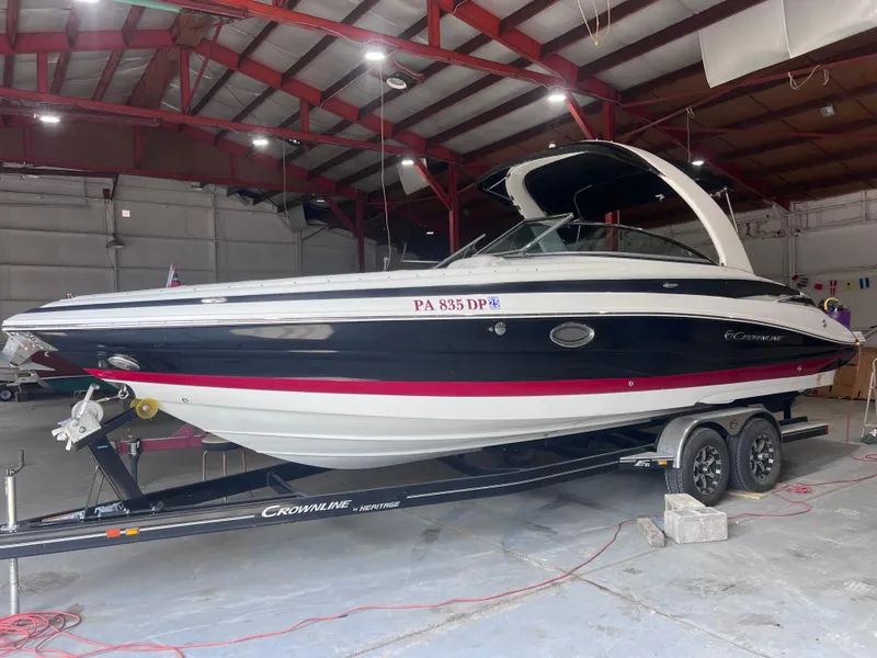 The Image of 2015 Crownline 285 SS boat on trailer in indoor storage facility. - 0