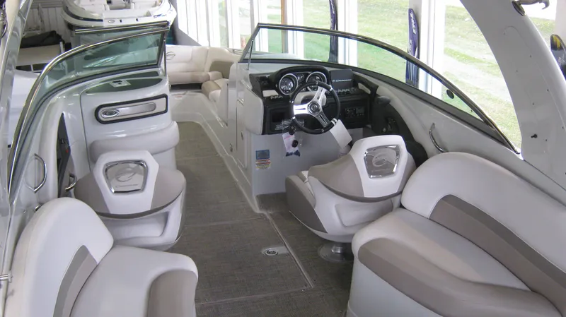 Slide: The Image of 2015 Crownline 285 SS boat interior with plush seating and modern dashboard. - 11