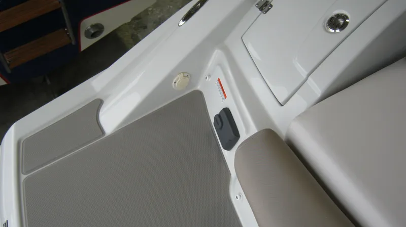 Slide: The Image of 2015 Crownline 285 SS boat interior with cushioned seating and storage compartments. - 13