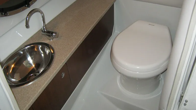 Slide: The Image of 2015 Crownline 285 SS boat bathroom with sink and toilet. - 17