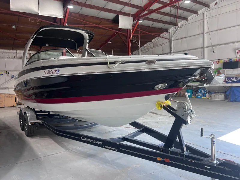 Slide: The Image of 2015 Crownline 285 SS boat on trailer in indoor storage facility. - 2