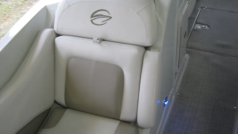 Slide: The Image of 2015 Crownline 285 SS boat interior with beige seating and logo. - 21