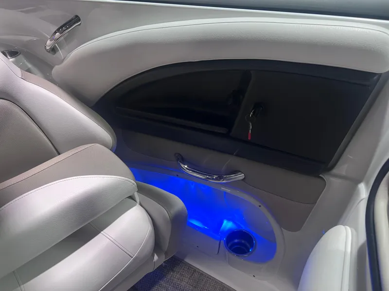 Slide: The Image of Interior of 2015 Crownline 285 SS boat with blue ambient lighting and sleek seating. - 29