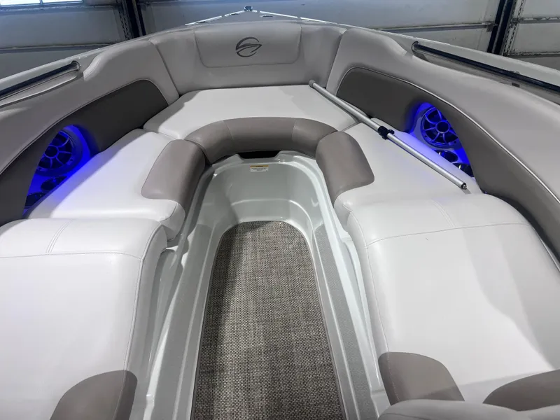 Slide: The Image of 2015 Crownline 285 SS boat interior with cushioned seating and blue LED lighting. - 30