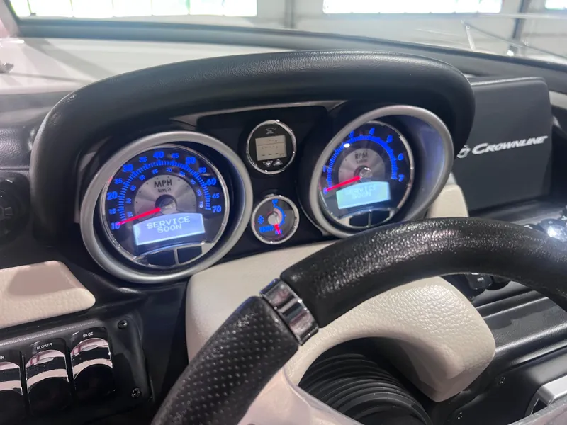 Slide: The Image of Dashboard of a 2015 Crownline 285 SS boat showing speedometer and service alert. - 31