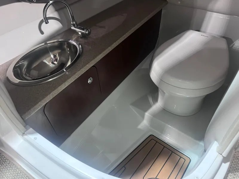 Slide: The Image of 2015 Crownline 285 SS boat bathroom with sink and toilet. - 33