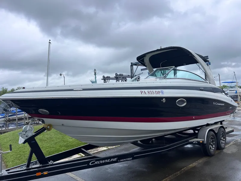 Slide: The Image of 2015 Crownline 285 SS boat on trailer under cloudy sky. - 4