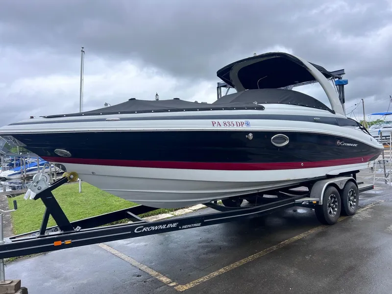 Slide: The Image of 2015 Crownline 285 SS boat on trailer, parked outdoors under cloudy skies. - 5