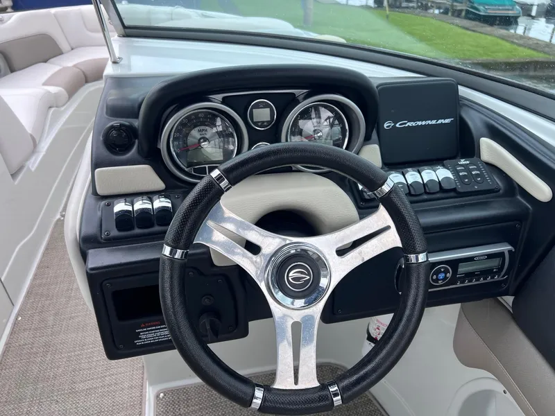 Slide: The Image of 2015 Crownline 285 SS boat dashboard with steering wheel and control panel. - 8