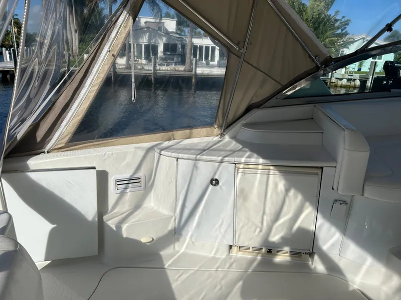 Slide: The Image of Interior view of a 2001 Formula 41 PC yacht with beige upholstery and waterfront backdrop. - 14