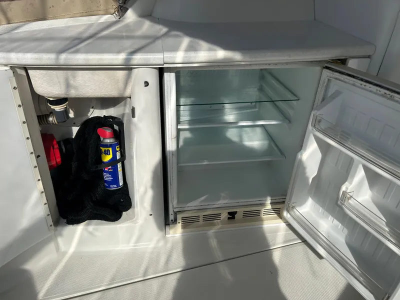 Slide: The Image of Open storage compartment and fridge on a 2001 Formula 41 PC boat. - 15