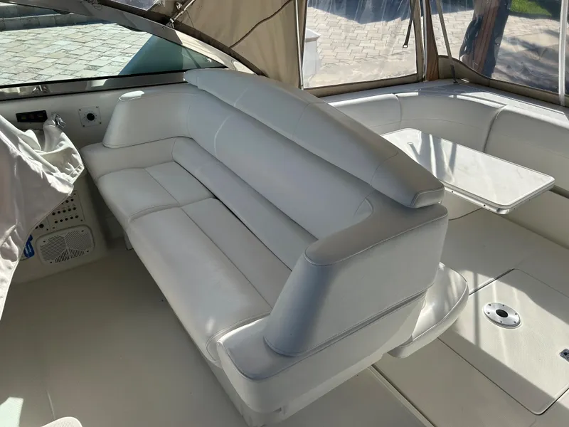 Slide: The Image of 2001 Formula 41 PC yacht interior with white leather seating and table. - 19