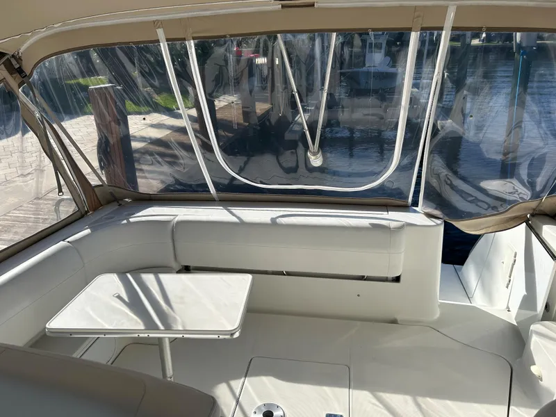Slide: The Image of 2001 Formula 41 PC yacht interior with seating and table, featuring clear enclosure. - 20