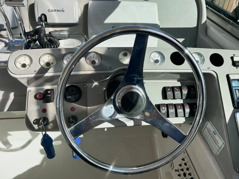 Slide: The Image of Steering wheel and dashboard of a 2001 Formula 41 PC boat with Garmin equipment. - 31