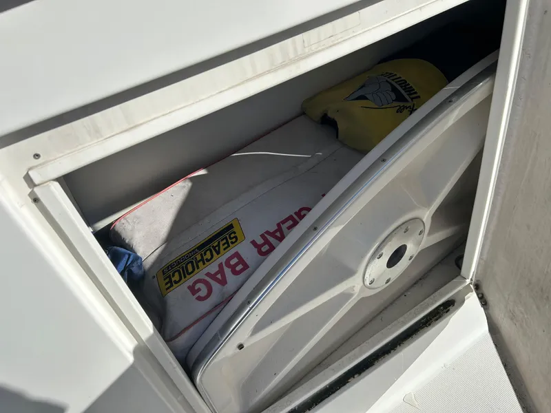 Slide: The Image of Storage compartment on a 2001 Formula 41 PC boat with gear bag and life jacket. - 6