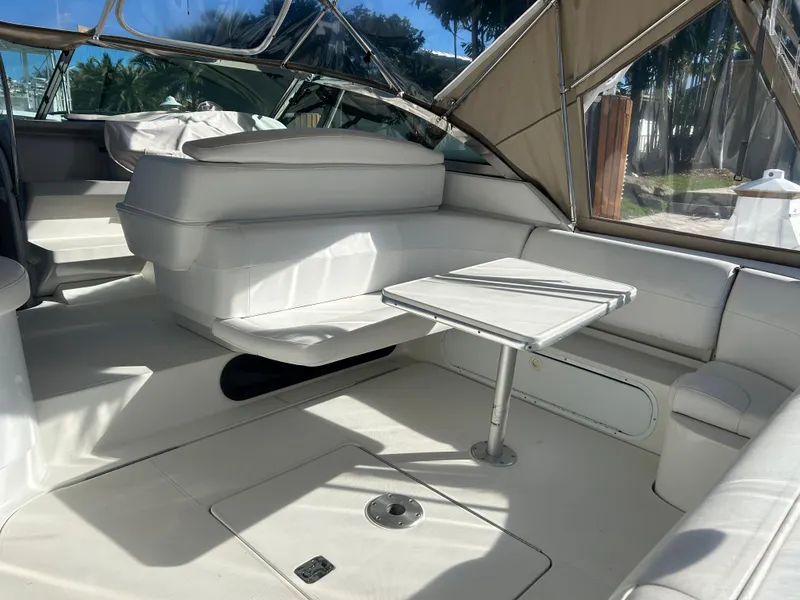 Slide: The Image of 2001 Formula 41 PC yacht interior with white seating and table, under a canopy. - 7