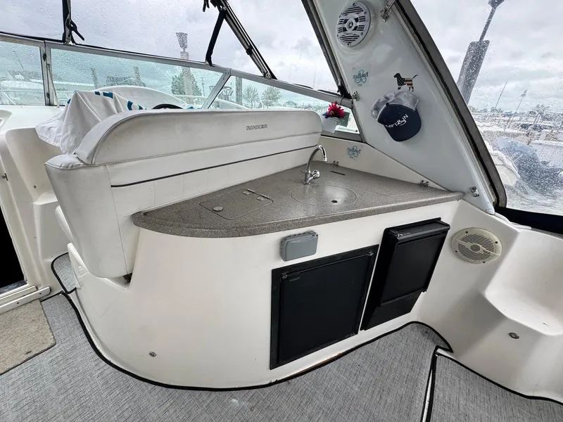 Slide: The Image of 2006 Rinker 342 Express Cruiser interior with kitchenette and seating area. - 10