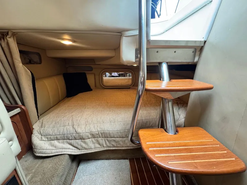 Slide: The Image of Interior cabin of 2006 Rinker 342 Express Cruiser with cozy bed and wooden steps. - 16