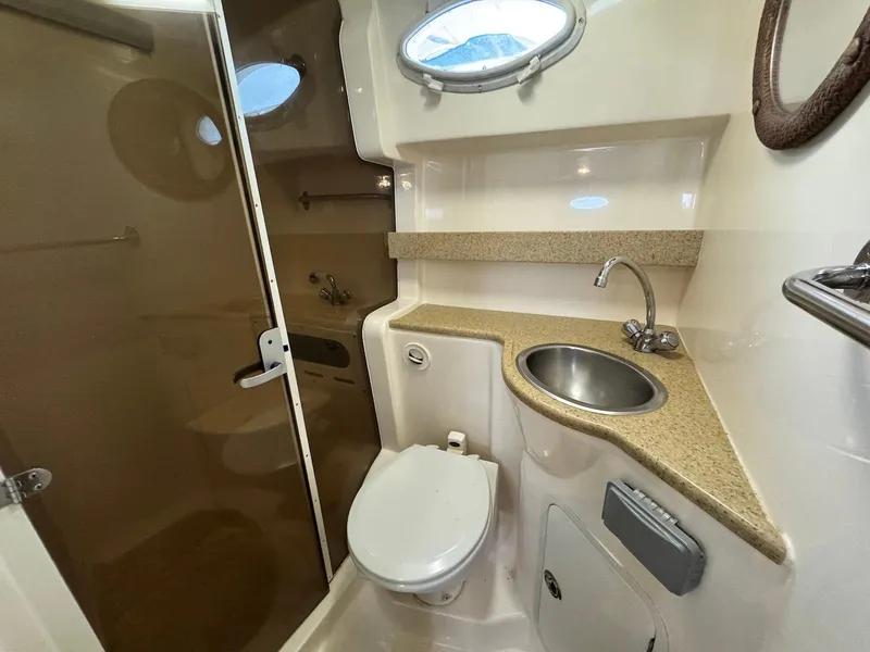 Slide: The Image of 2006 Rinker 342 Express Cruiser bathroom with sink, toilet, and shower. - 18